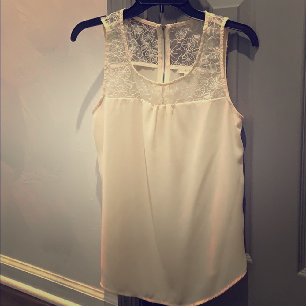 Sleeveless white lace blouse